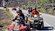 Guests riding motoquads on a road in Catania, Italy